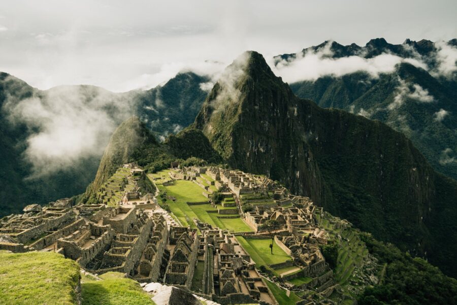Lush green grass and the different levels of Machu Picchu on a cloudy day