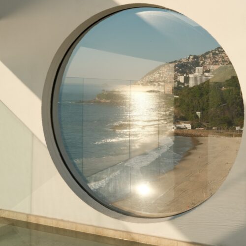 A few of Leblon beach from the circle window at Janeiro Hotel