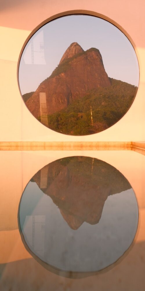 Dois Irmãos (Two Brothers) rocks captured through the circle window at Janeiro Hotel