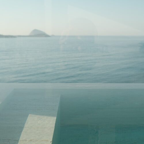 A hotel infinity pool with the ocean in the distance