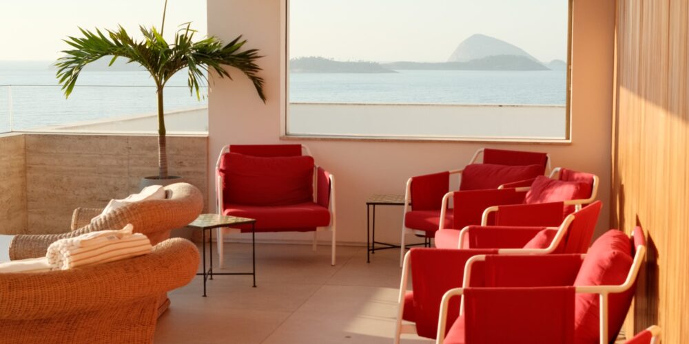Red chairs at sunrise on the Janeiro Hotel terrace