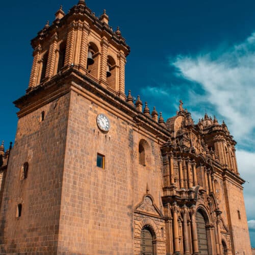 Cusco Cathedral with tourists walking in front