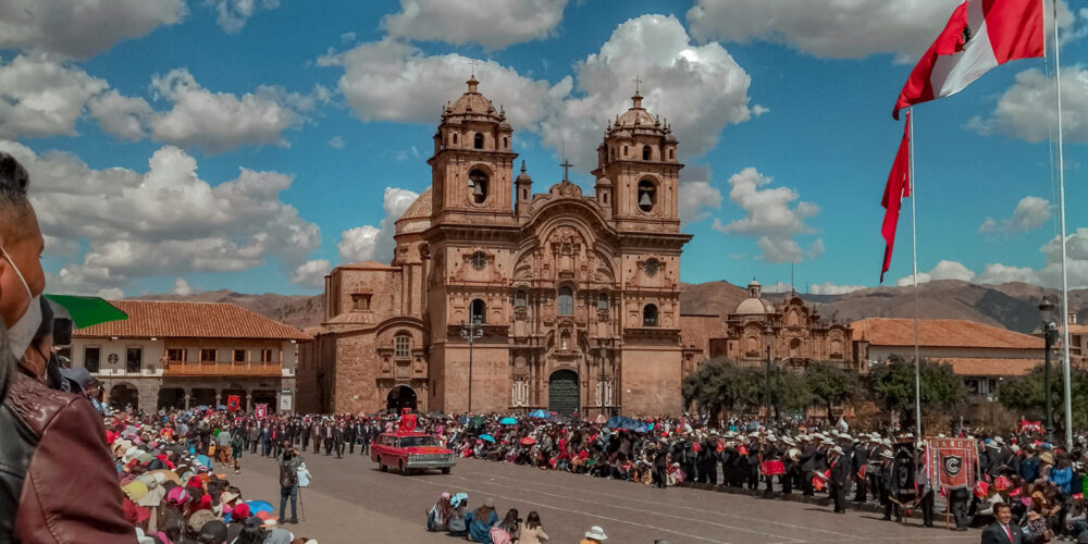 Festival in Plaza de Armas with a large Peruvian flag