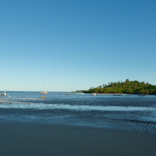 Moreré beach on Boipeba in the afternoon with the tide out and boats on the sand